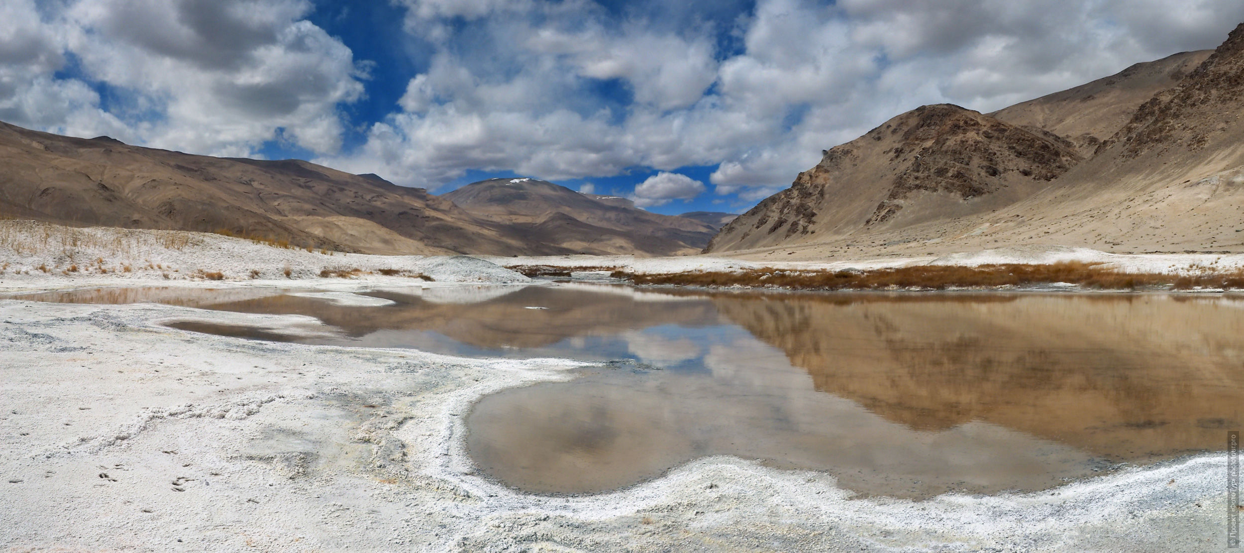 Alpine valley of geysers near Tso Kar lake, Ladakh. Advertising Tibet Lake Tour: Alpine lakes, valley of geysers, Lamayuru, Tsvetnoye Gory, 01 - 10.09. 2022 year.