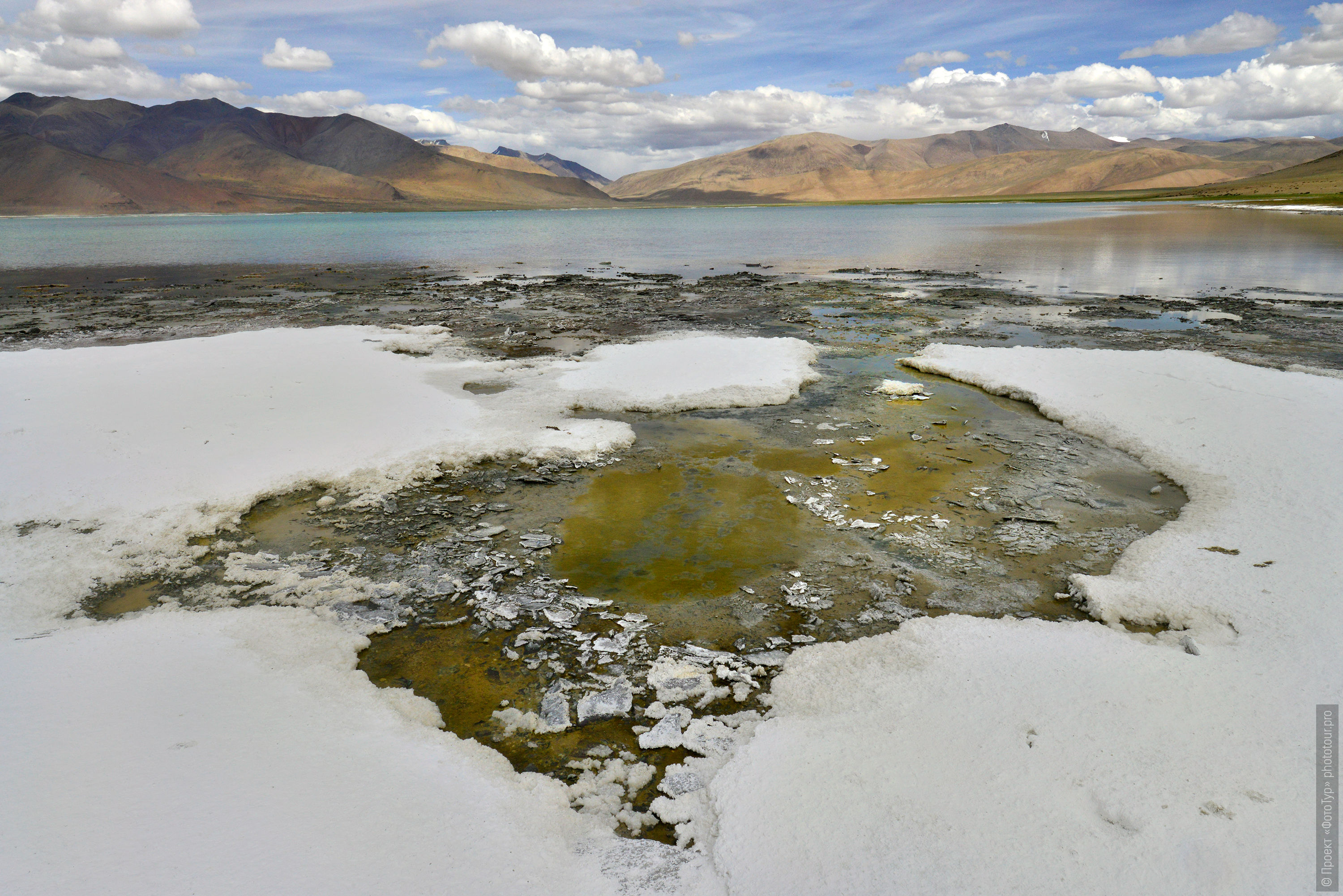 Salt crust on the shore of Lake Tso Kar, Rupshu Valley. Tour Tibet Lakeside Advertising: Alpine lakes, geyser valley, Lamayuru, Colored Mountains, 01 - 10.09. 2022 year.